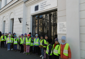Dzieci stoją przed wejściem do Centralnego Muzeum Włókiennictwa.